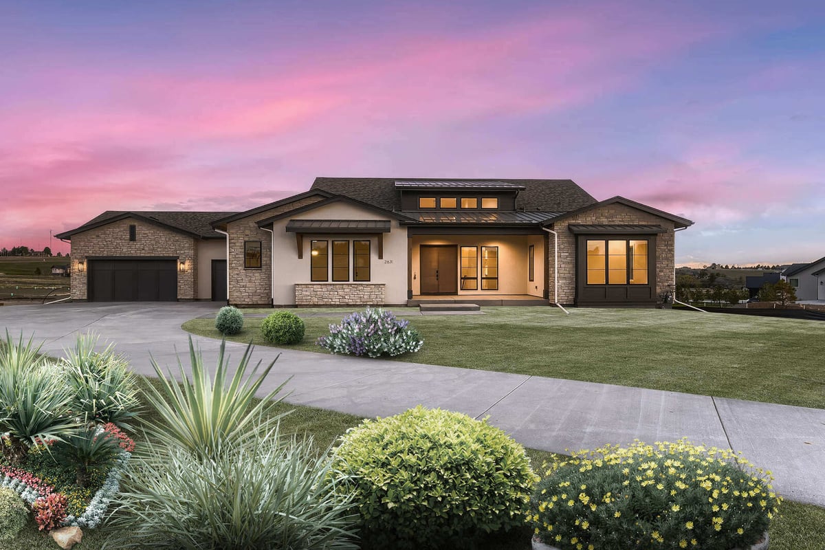 Front view of a custom-built ranch-style home by Sheffield Homes in Denver, CO, under a vibrant sunset sky