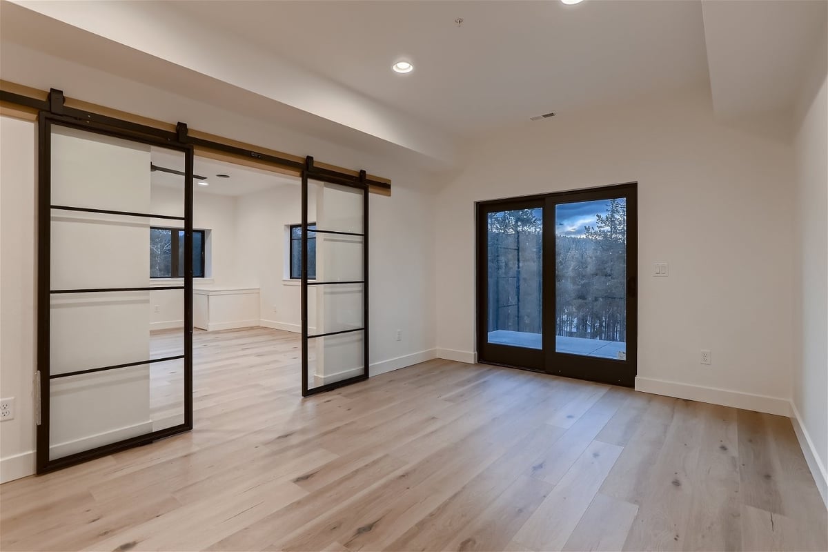 Open hallway with sliding doors in basement finished by Sheffield Homes, Denver, CO